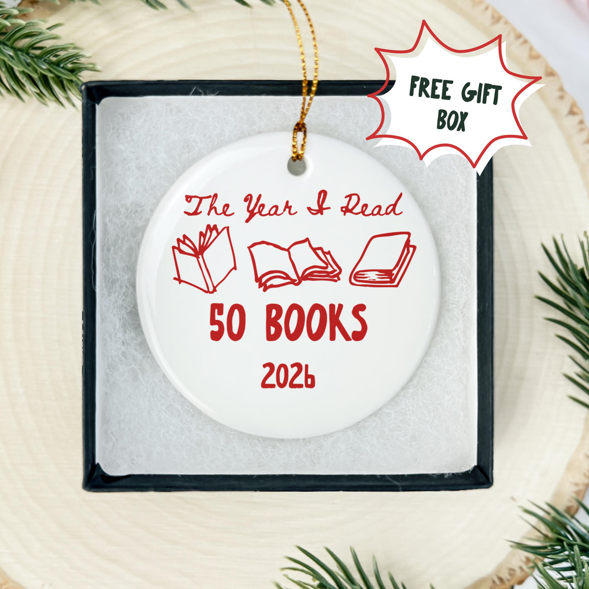 White round porcelain Christmas ornament displayed in a black gift box, featuring red open books and customizable text The Year I Read 50 Books 2026.